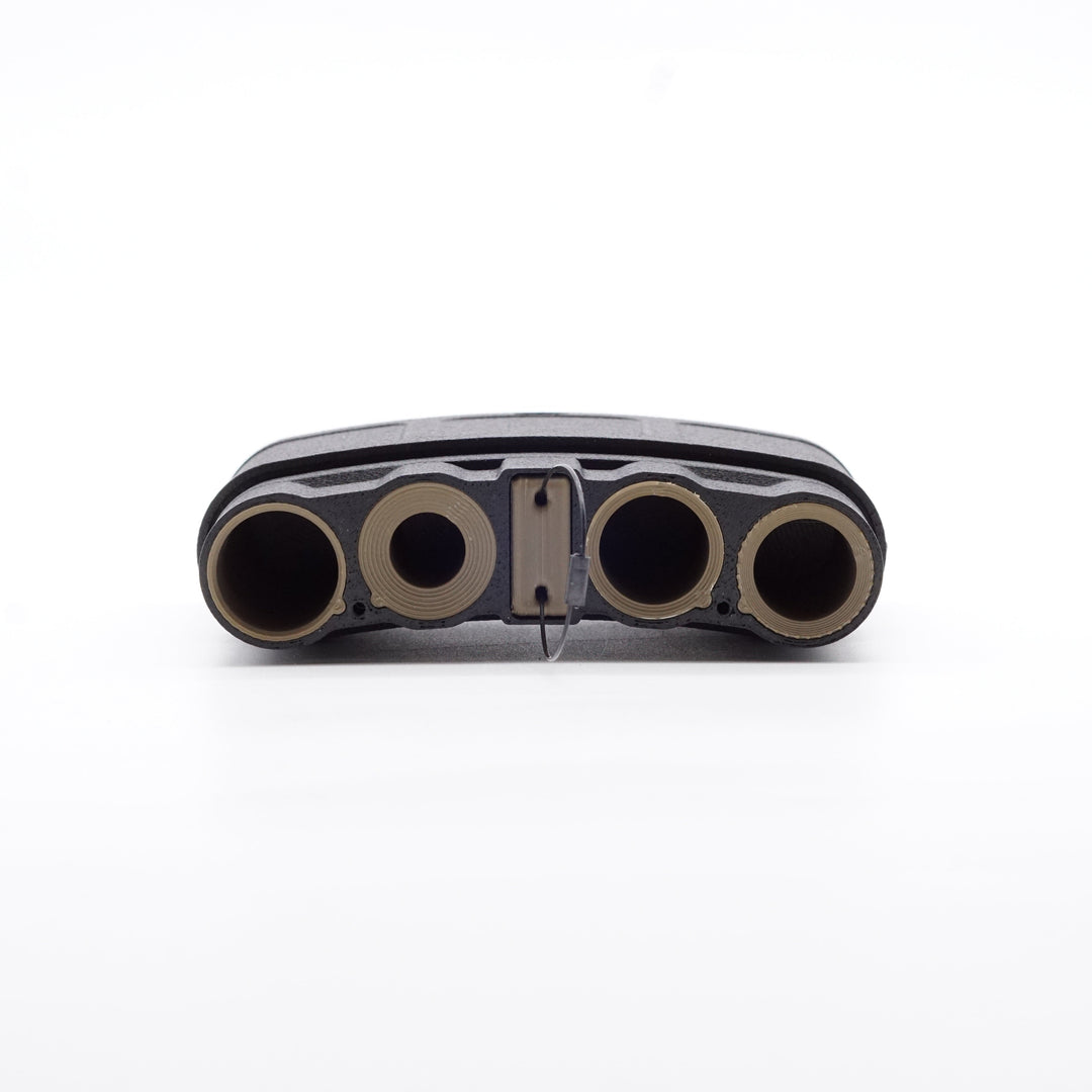 NODSBACK™ unit lying on the ground open showing a battery load out with CR123, AAA, CR2 and AA from left to right. Sleeve color is the dark earth option. 