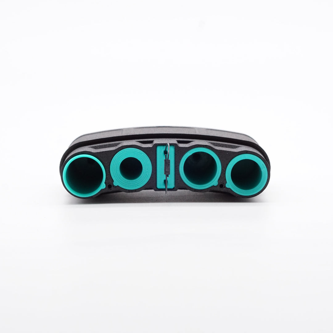 NODSBACK™ unit lying on the ground open showing a battery load out with CR123, AAA, CR2 and AA from left to right. Sleeve color is the paradise blue option. 