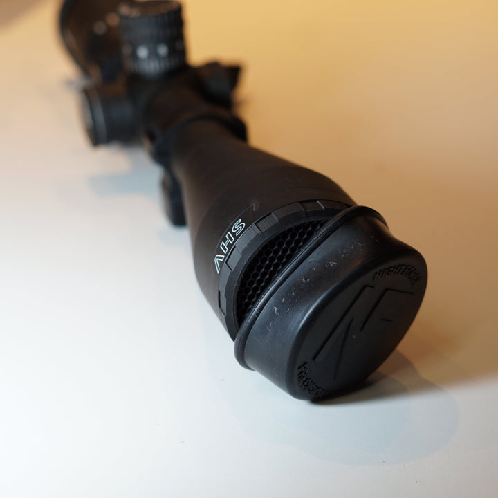 Paradise Tactical ARD installed on a Nightforce scope showing that the ARD does not impede scope cover usability. 