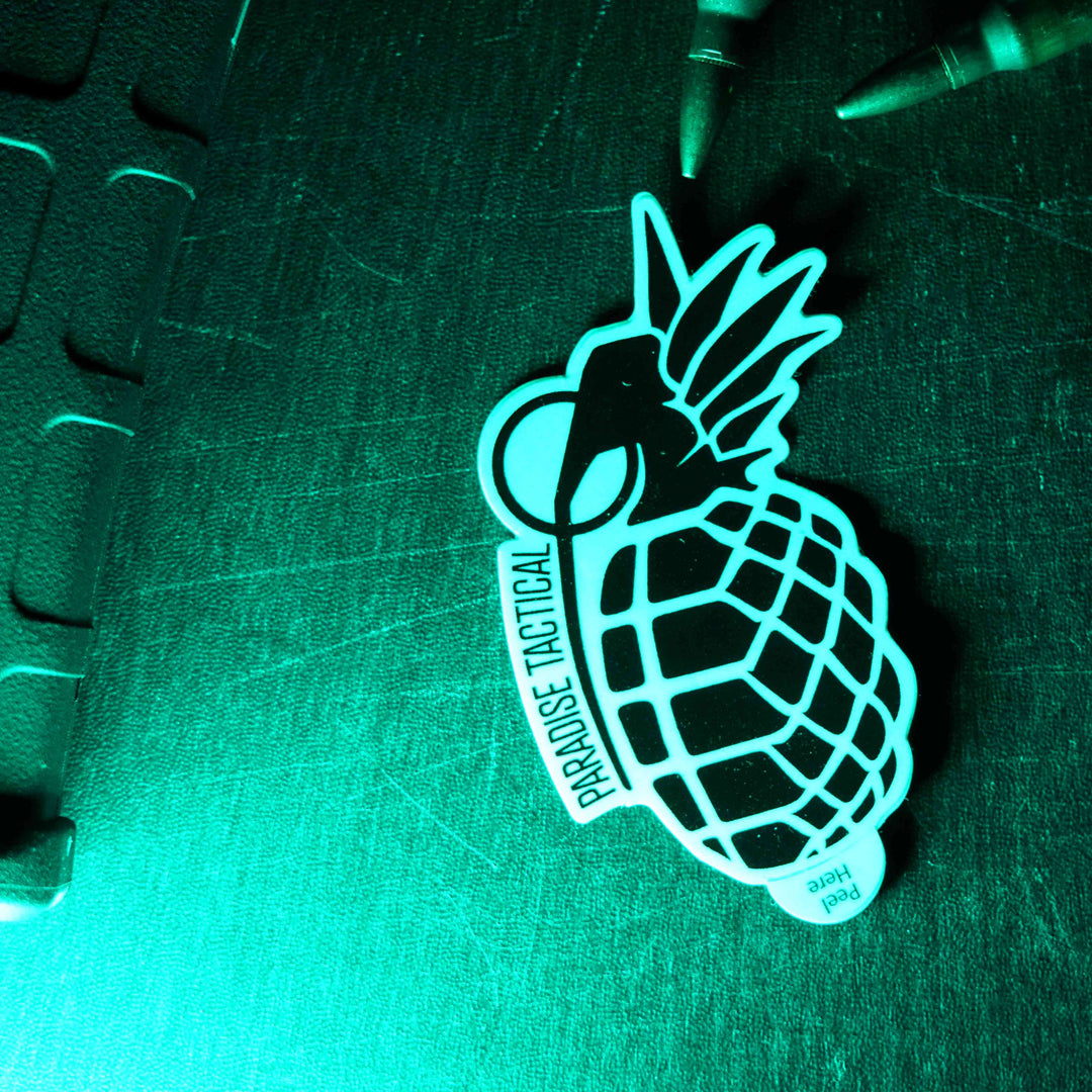 paradise tactical OG sticker with a 556 pmag, rounds, and an FN pistol