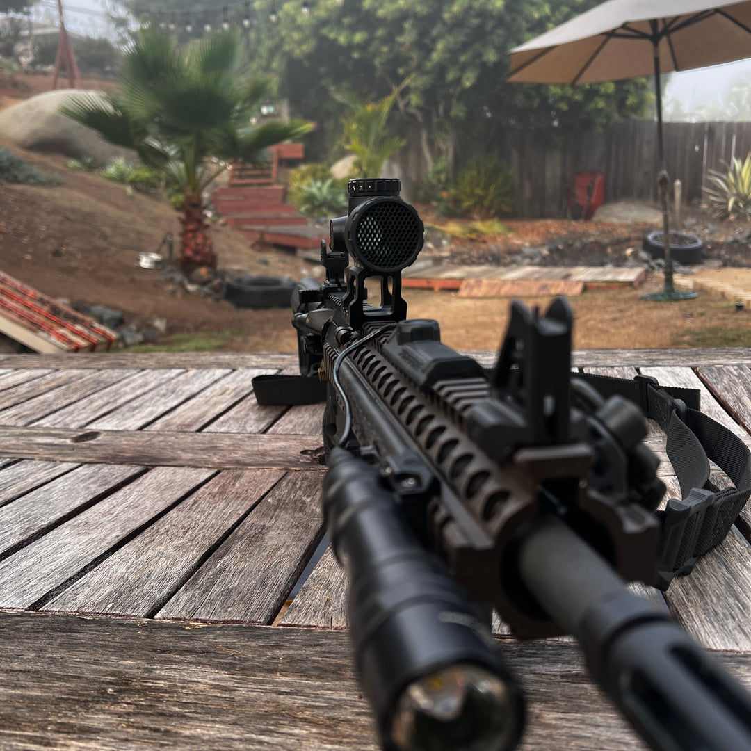 A black anti reflective device (ARD) designed for a Trijicon MRO red dot optic, shown mounted on the optic.