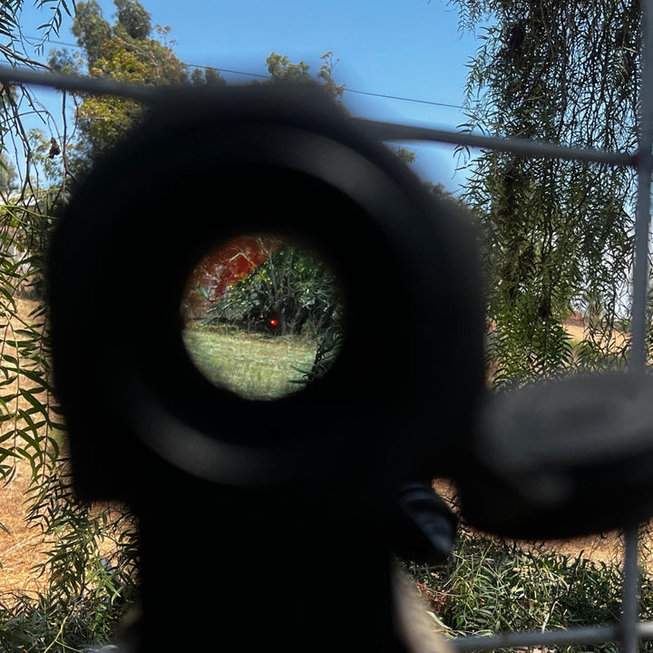 Field Image of a Vortex Sparc AR black antireflective device (ARD) designed for a Vortex Sparc AR red dot optic, shown with minimal viewing obstruction. The ARD is installed on an optic with a hexagonal pattern on the front. Optic snaps onto place and allows for full use of OEM dust covers.