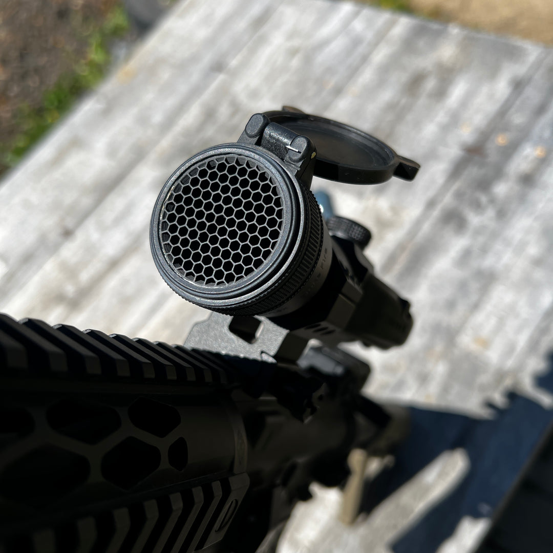 Vortex StrikeFire black antireflective device (ARD) with a hexagonal pattern on the front designed for a Vortex StrikeFire red dot optic, threads into the optic allowing operation of OEM dust covers.